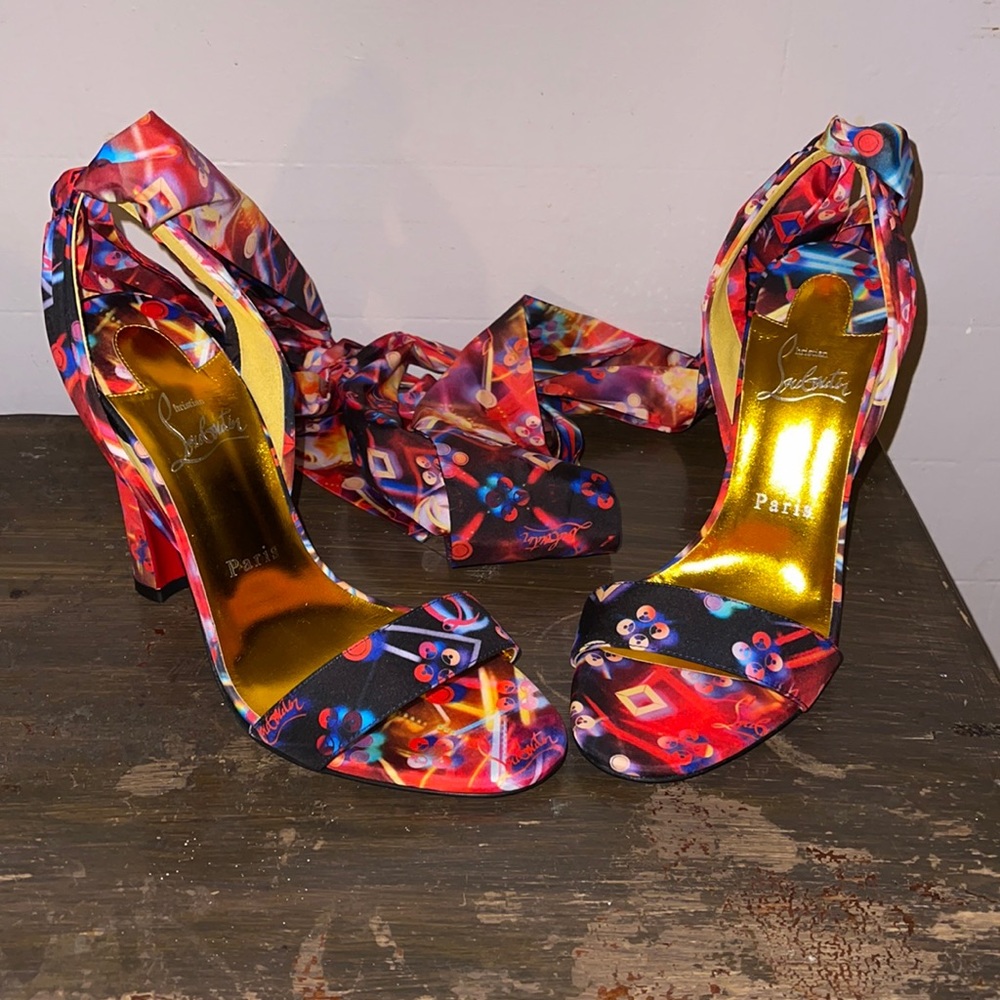 A colorful disco-inspired wraparound heel.  Christian Louboutin's. Never Worn